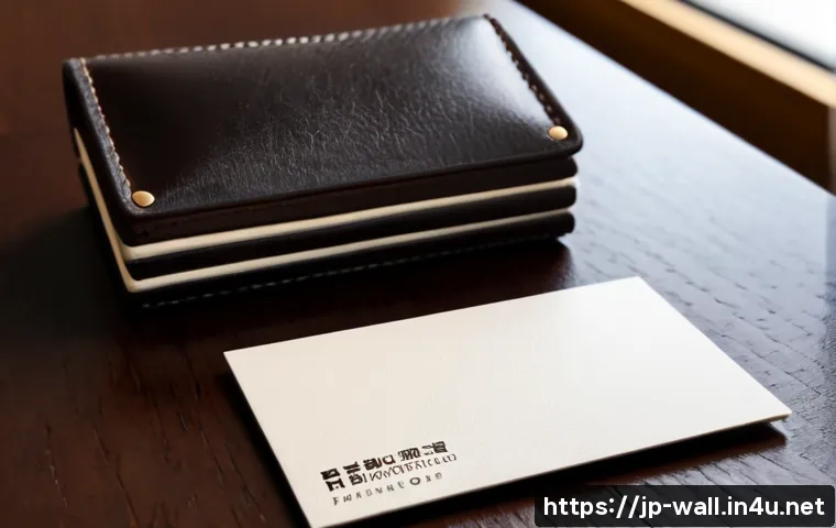 몽블랑 명함 지갑과 돈클립 지갑 비교 - Photorealistic luxury leather business card holder resting beside a small stack of blank cream busin...